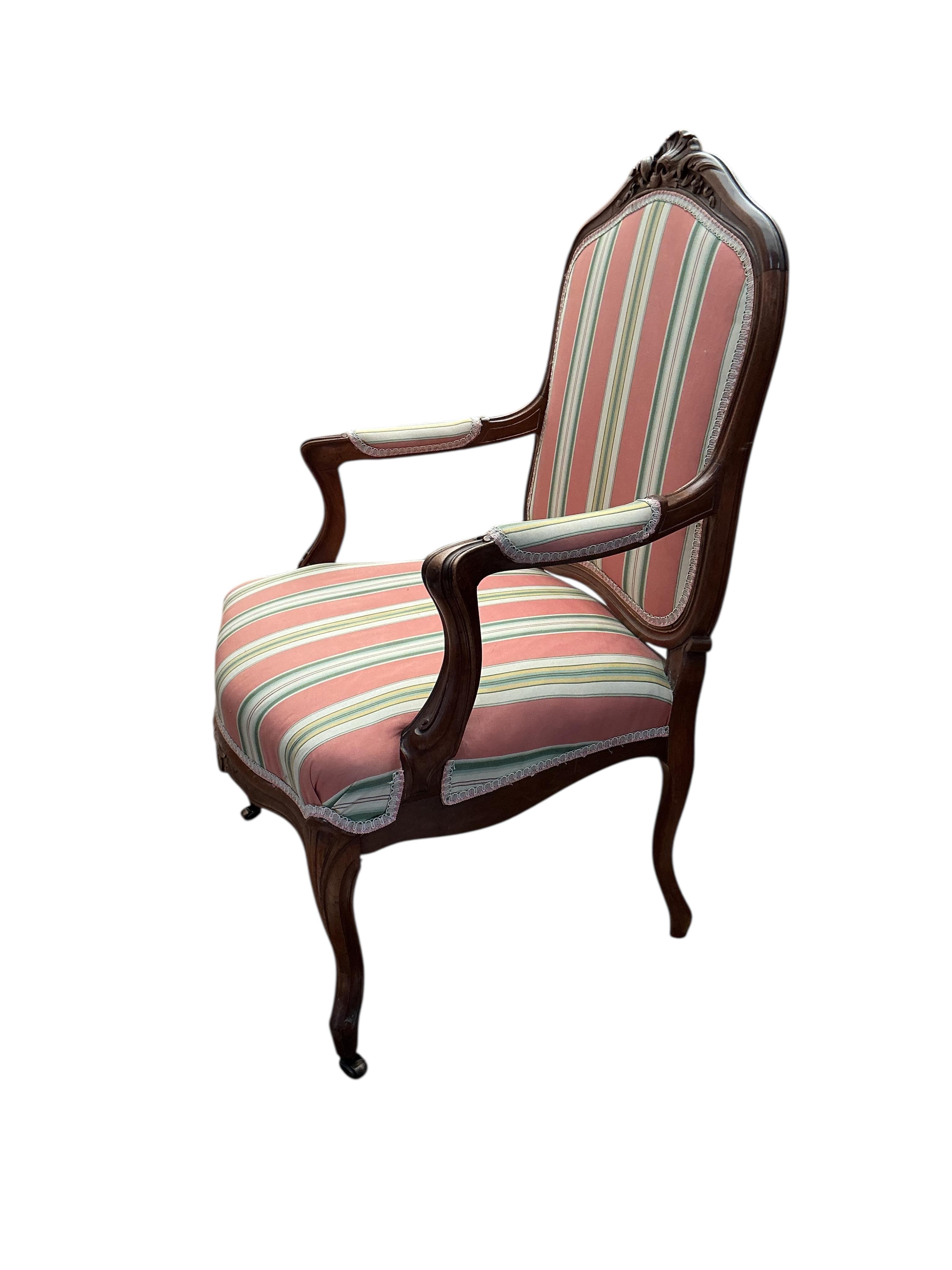 A reproduction Louis XV style walnut upholstered fauteuil, width 66cm, depth 52cm, height 98cm